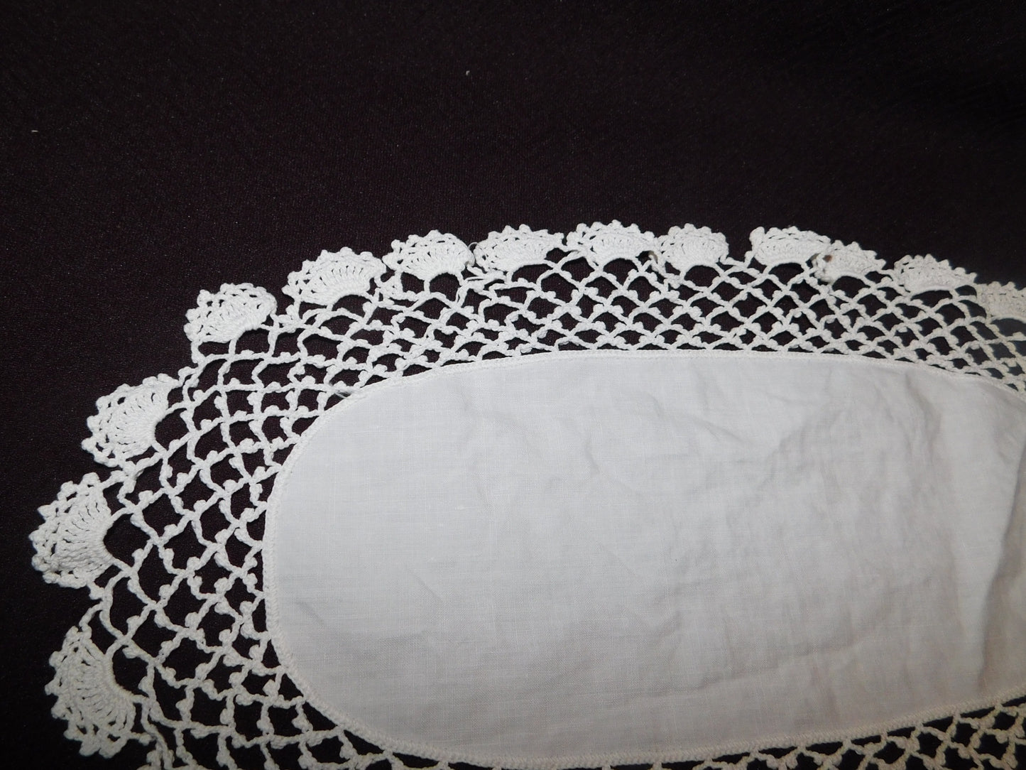 Vintage 13 x 7 oval crocheted doily with linen center