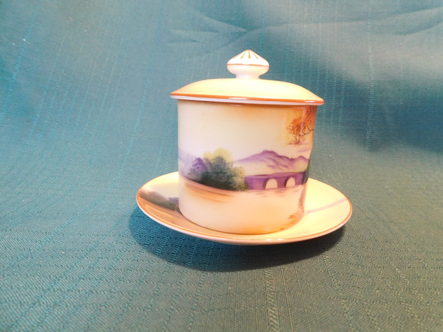 Antique Noritake M (1911) bridge scene lidded condiment jar with underplate VGU