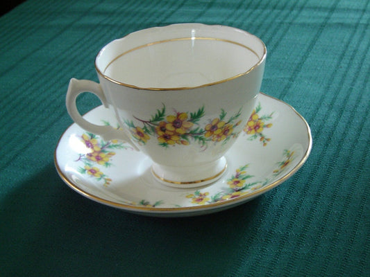 Royal Vale yellow flower green leaves cup and saucer - Items Tried And True