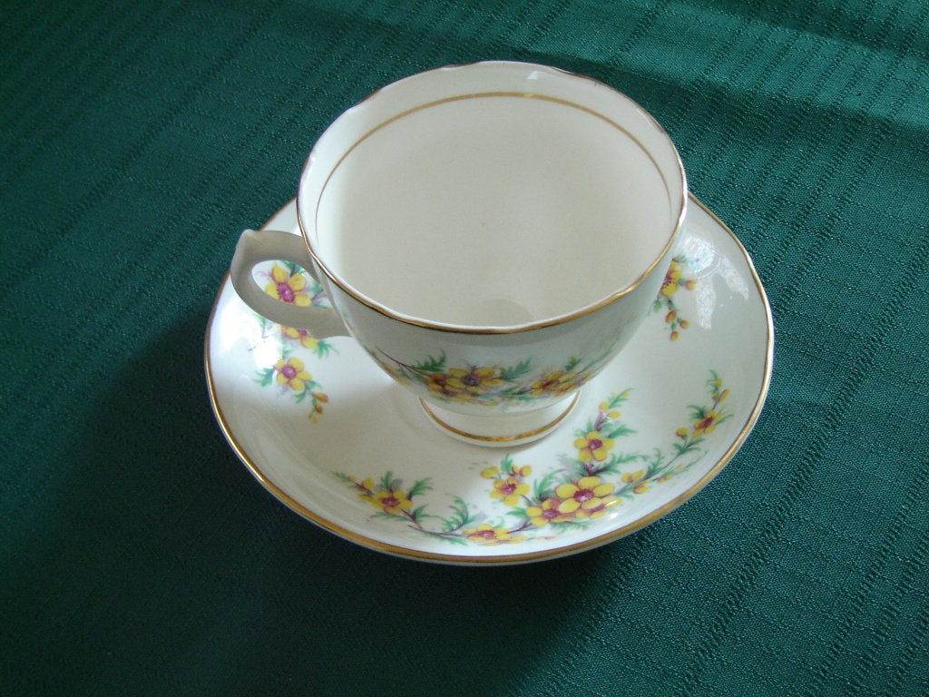 Royal Vale yellow flower green leaves cup and saucer - Items Tried And True