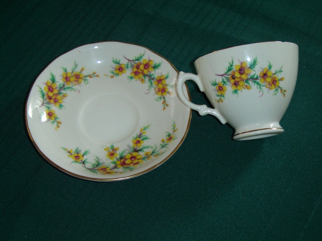 Royal Vale yellow flower green leaves cup and saucer - Items Tried And True