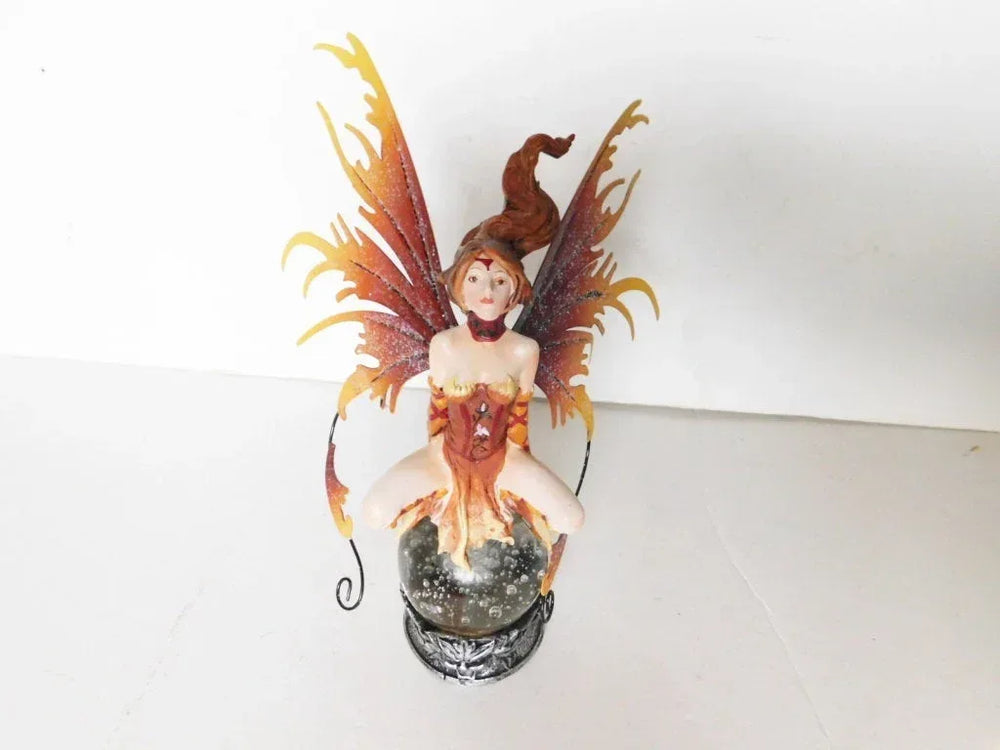 Seated brown faerie on crystal ball