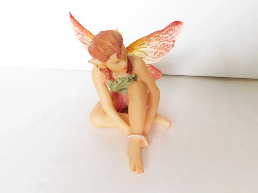 Seated green pink faerie
